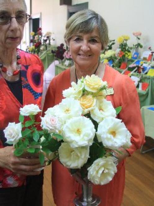 Val Clarke, of Oamaru (left), holds her vase of ''Irresistible'', the champion miniature rose,...