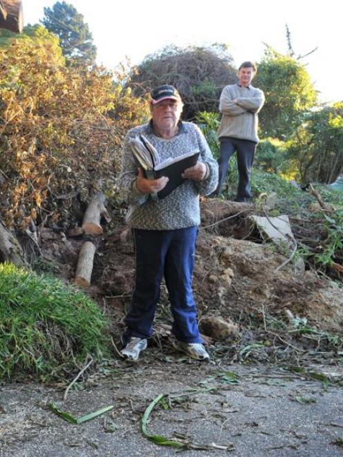 Vauxhall residents Trevor Young (left) and Philip Burns survey the landslip above Portobello Rd....