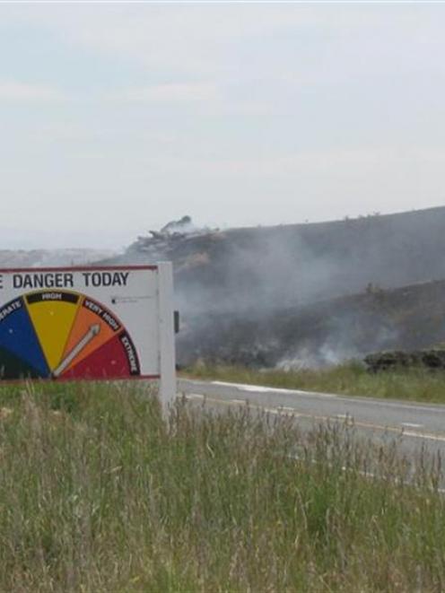 Vegetation smoulders after yesterday's fire at Flat Top Hill, near Alexandra. Photo by John Douglas.