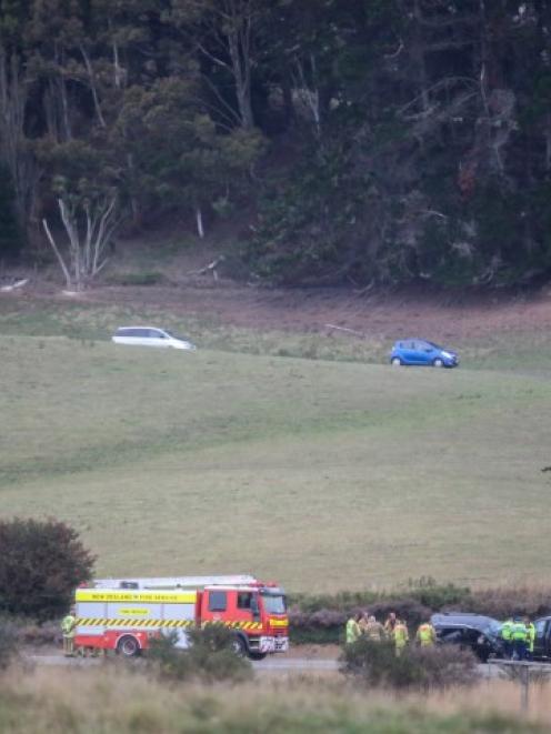 Vehicles (at top) detour through a farm as emergency services attend the scene of the crash....