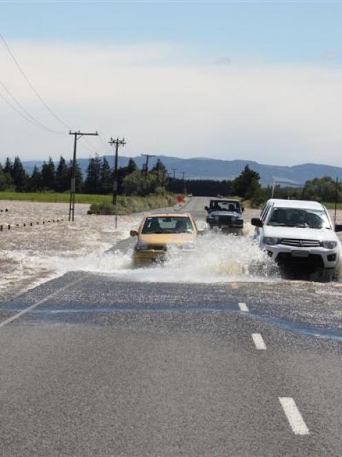 Vehicles  negotiate flooding on the Rakahouka-Hedgehope Rd, about 5km south of Hedgehope, where...