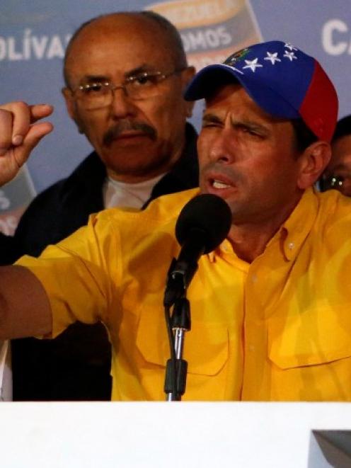 Venezuela's opposition leader Henrique Capriles gestures during a news conference in Caracas...