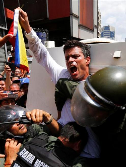 Venezuelan opposition leader Leopoldo Lopez gets into a National Guard armoured vehicle in...