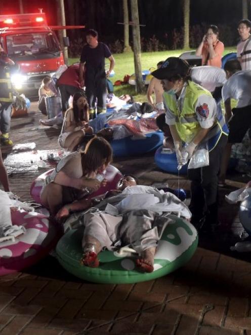 Victims of the blast lie on the ground at the Formosa Water Park in New Taipei City, Taiwan....