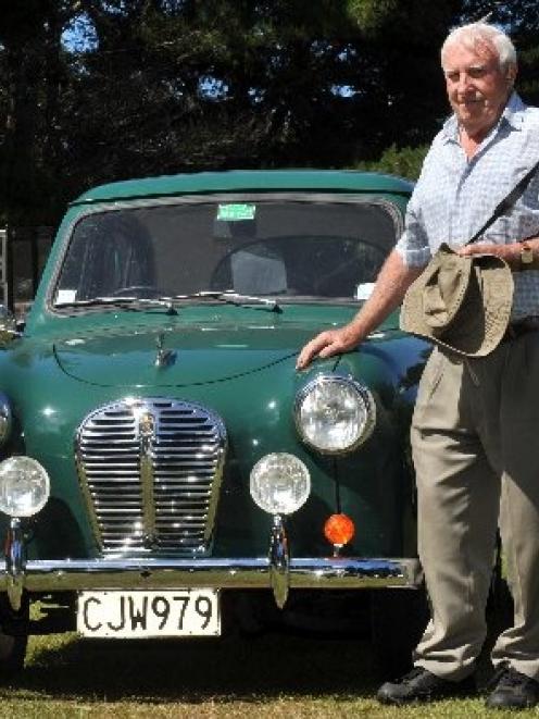 Vintage Austin Register member John Gertson stands in the sun with his 1955 A30 Austin at Music...