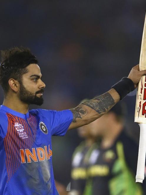 Virat Kohli celebrates his side's victory over Australia. Photo Getty