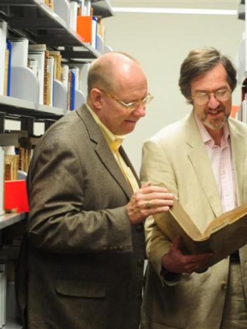 Visiting rare book experts Eric Holzenberg, from New York, and David Pearson, from London, study...