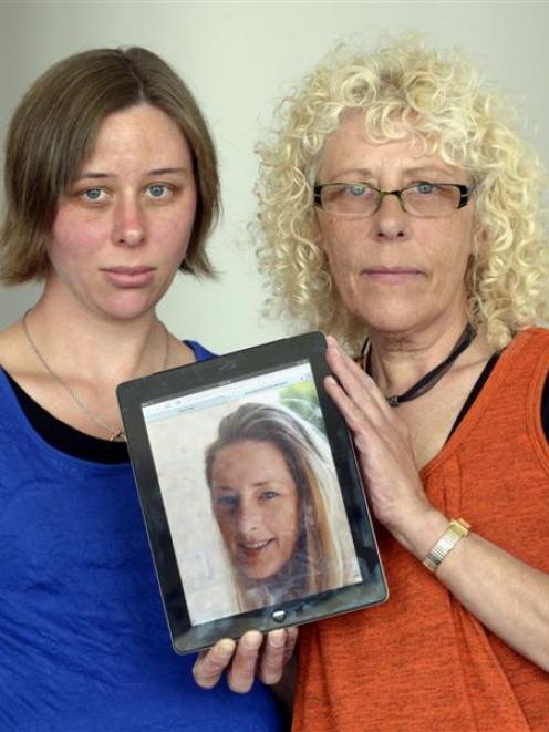 Vivien McKenzie and her daughter Kylie Maloney, both of Dunedin,  hold a picture of their late...