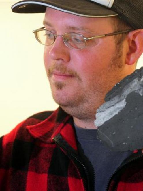 Volcanologist Mick May with fragments from the Pink and White Terraces in the University of Otago...