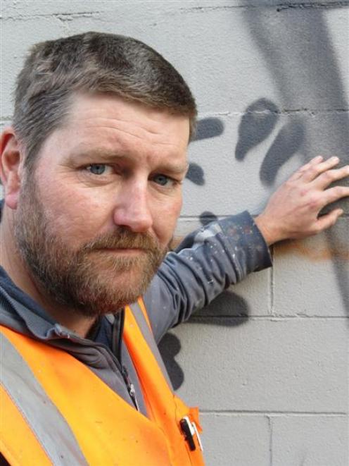 Volunteer Darryl Angus removes graffiti for the Dunedin City Council. Photo by Jonathan Chilton...