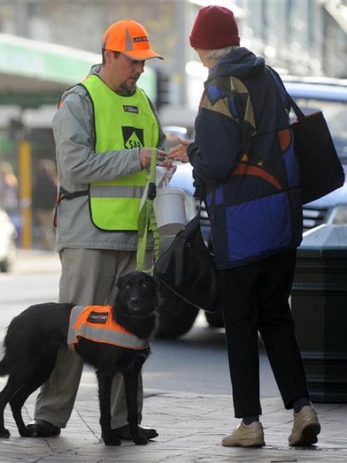 Volunteer Steve Fyfe with Dart collects for Land SAR in George St, Dunedin, during a fundraising...