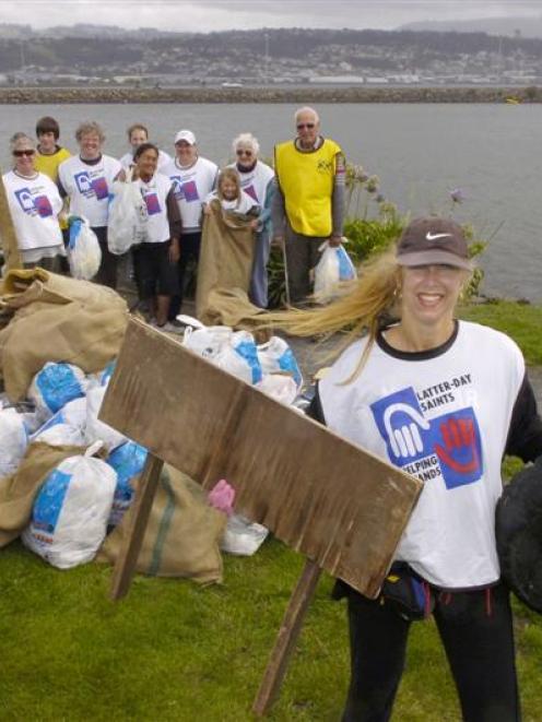 Volunteers from the Church of Jesus Christ of the Latter-Day Saints with rubbish collected during...