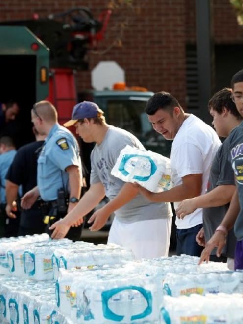 Volunteers unload drinking water from a truck outside Waite High School in Toledo, Ohio. REUTERS...