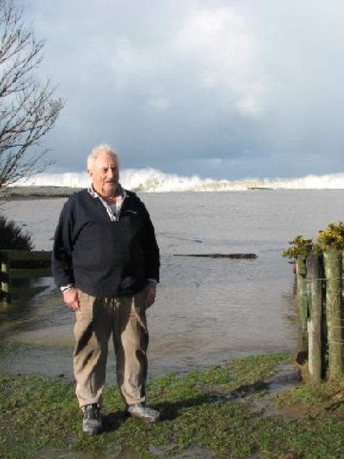 Waimate farmer Murray Bruce beside the Waihao River mouth after last week's heavy rain. Behind...