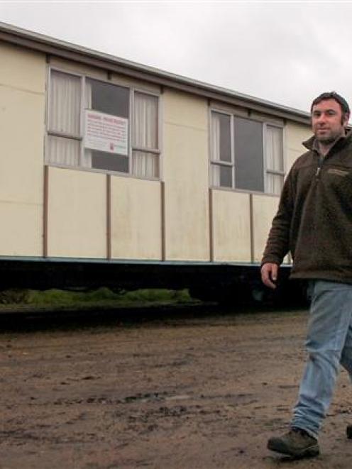 Waiora Scout Camp groundsman Stephen Manning walks past one of the new prefabs to be installed...