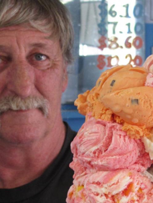 Waipapa shop owner Mike Pickett shows off the 10-scoop, 1.9kg Death By Ice Cream. Photo / NZME.