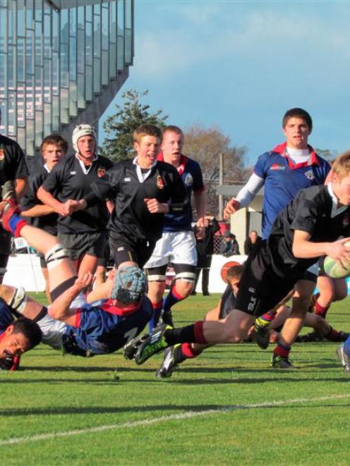 Waitaki Boys' fullback Jamie Robb crosses for a try against St Kevin's in Oamaru yesterday. Photo...