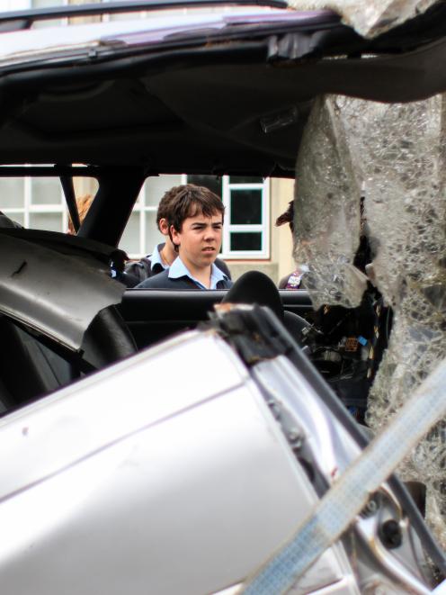 Waitaki Boys' High School pupil Hamish McEwan (14) takes a look at the car former pupil Scott...
