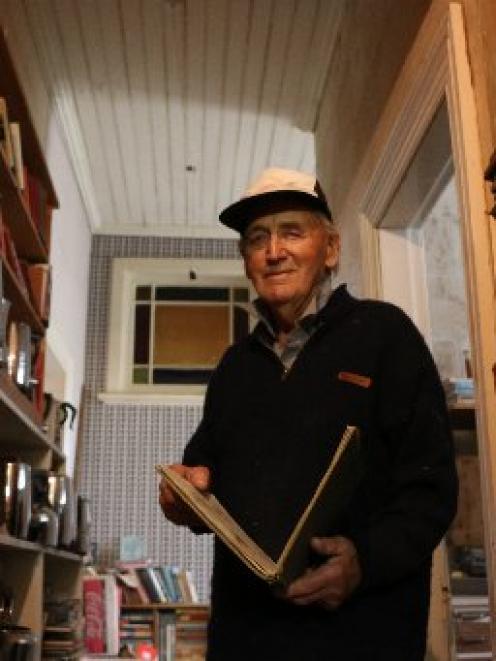 Waitaki Community Society member Bob Watherston picks out one of the estimated 10,000 books in...