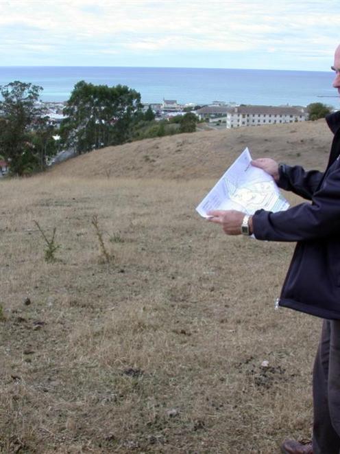 Waitaki District Council property manager Dougall McIntyre with subdivision plans for land above...