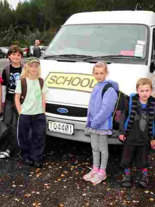 Waitati School pupils ready to board their bus at the school are (from left) James Burchell (9),...