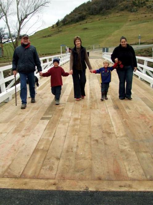 Walking across the newly-opened Tuapeka Mouth bridge yesterday are, from left, Patrick Lomas and...