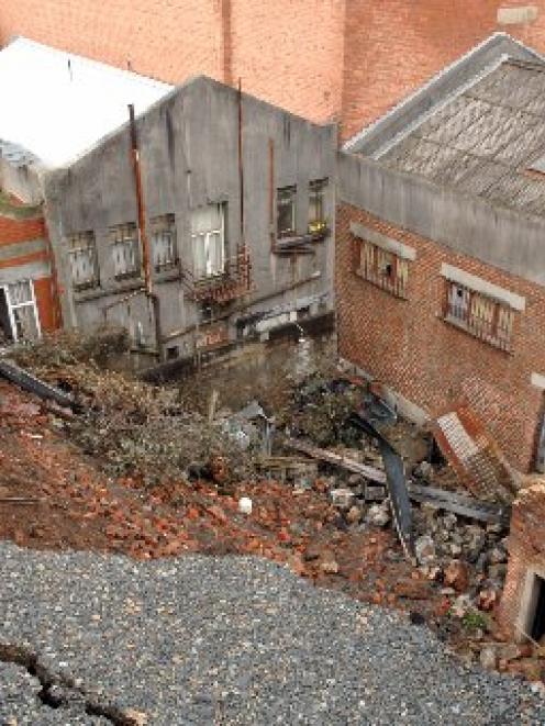 Bluestone from the collapsed wall between Dowling and Rattray Sts will be sold as salvage. Photo...