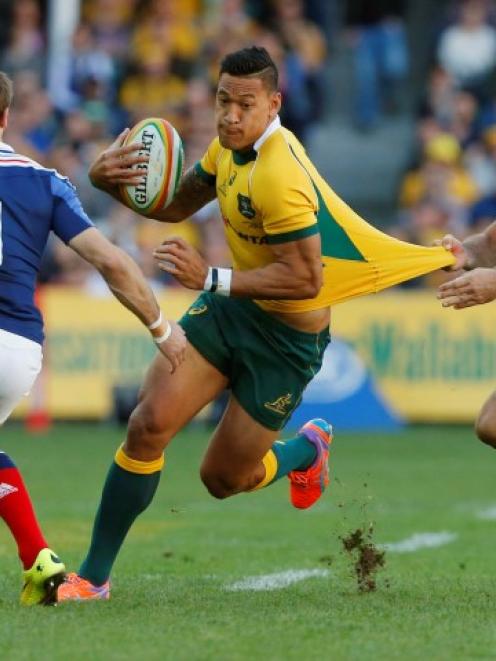 Wallaby fullback Israel Folau gets through the defence of France's Hugo Bonneval (L) and Remi...