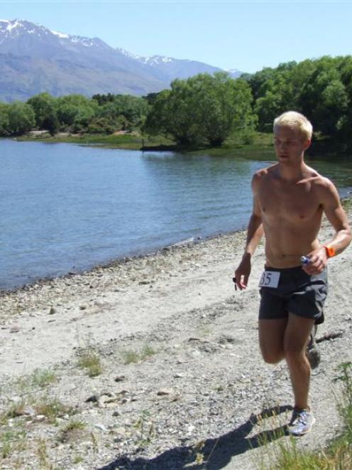 Wanaka-based runner Jimmy Lawrence (25), of the United States, runs along the shore of Lake...