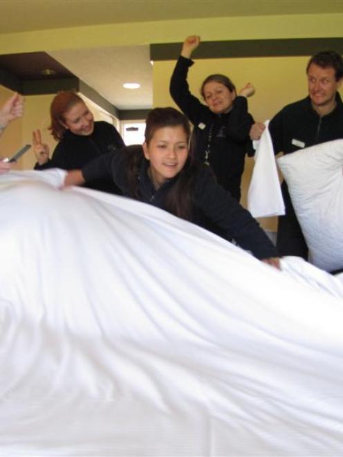 Wanaka housekeeper Pamela Pittaway, New Zealand's top-ranked bedmaker, demonstrates her skills...