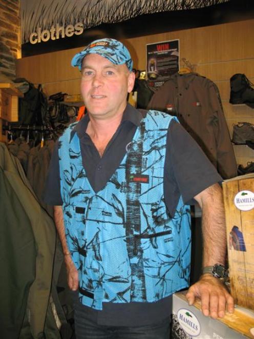 Wanaka retailer Mark Sanders models his 'blaze blue' hunting range in his shop on Thursday. Photo...