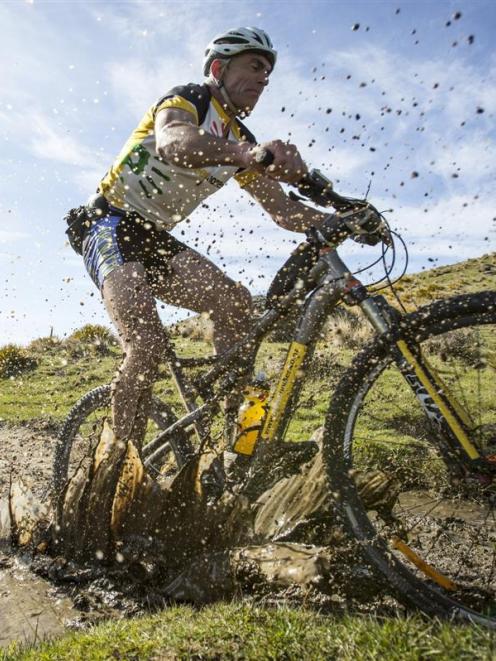 Wanaka's Keith Murray shows he is still made of tough stuff, splashing through a puddle in the...
