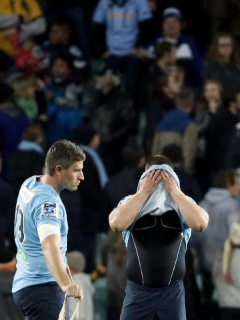 Waratahs players react after their loss to the Highlanders in Sydney on Saturday night. REUTERS...