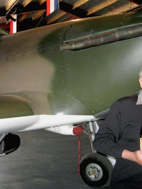 Warbirds Over Wanaka founder Sir Tim Wallis displays a bottle of wine produced to commemorate the...