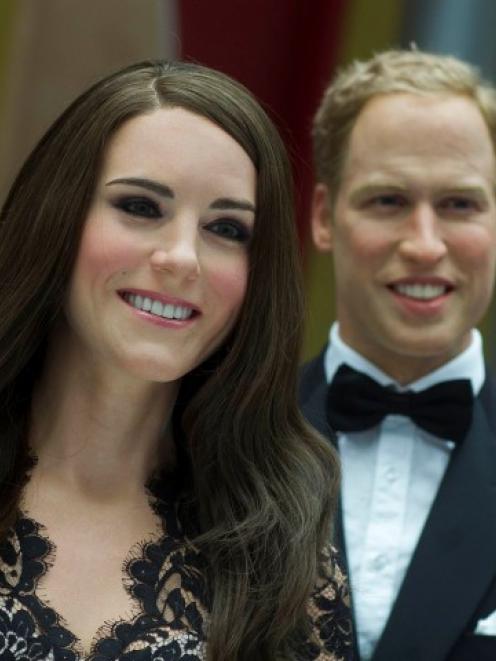 Wax figures of Kate Middleton, Duchess of Cambridge, and Prince William are displayed during a...