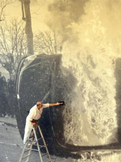 Wayne Jenkins, of Holmes Decorating, puts the finishing touches to the  installation of Double...