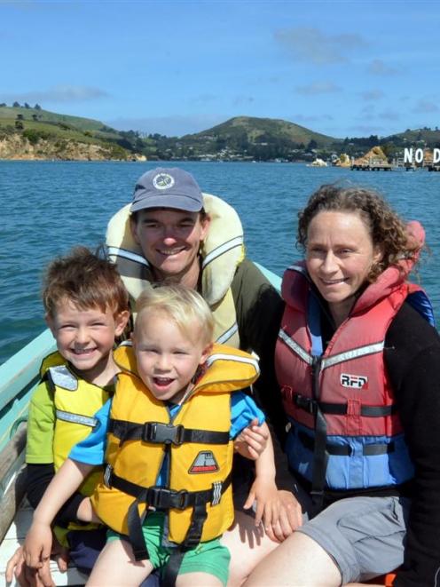 Wayne Johnson, Anna Hughes and their sons, Eli (left) and Niwha, head for home after a day in...