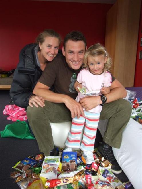 Wayne Oxenham, with the help of wife Lynne and daughter Ashley, packs his bag full of sweets in...