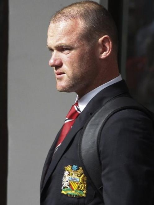 Wayne Rooney arrives at Thailand's Don Muang International Airport for Manchester United's...