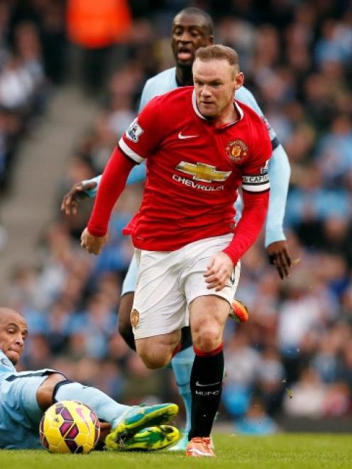 Wayne Rooney (C) in action recently for Manchester United against Manchester City. REUTERS/Andrew...