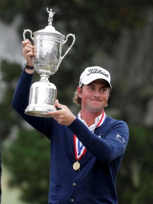 Webb Simpson of the US holds the trophy after winning 2012 US Open on the Lake Course at the...
