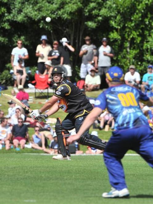 Wellington batsman Jesse Ryder plays uppishly as Nick Beard positions himself for an unsuccessful...