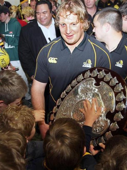 Wellington replacement No 8 Thomas Waldrom holds the Ranfurly Shield after arriving at Wellington...