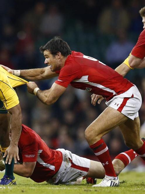 Welsh players attempt to bring down Australia's Kurtley Beale.  REUTERS/Darren Staples