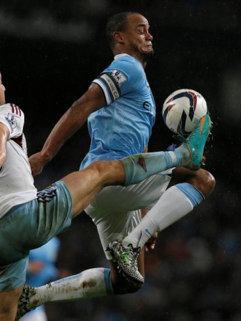 West Ham's Joe Cole (L) challenges Manchester City's Vincent Kompany. REUTERS/Phil Noble