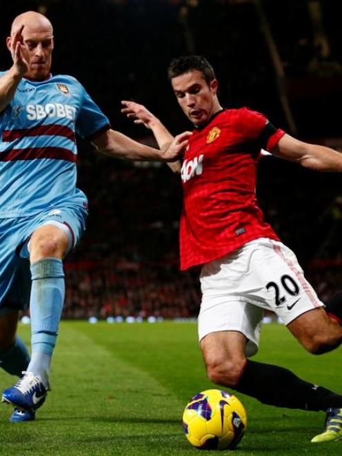 West Ham United's James Collins challenges Manchester United's Robin van Persie.   REUTERS/Darren...