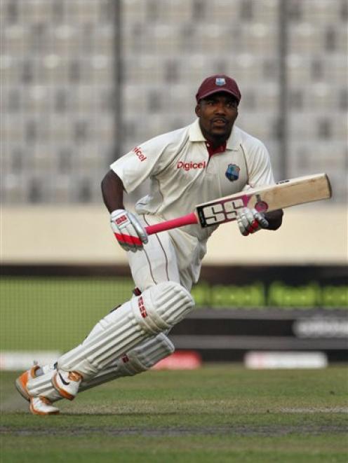 West Indies batsman Darren Bravo scores a run to make his first international century during the...