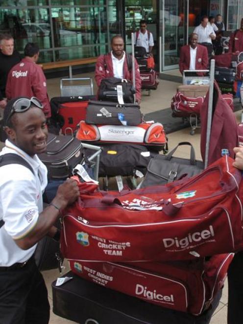 West Indies batsman Xavier Marshall (left) and team physio CJ Clark load gear into the team truck...