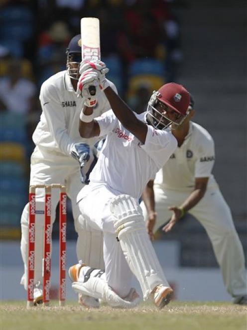 West Indies' Darren Bravo hits India's Harbhajan Singh for four during the fifth day of the...