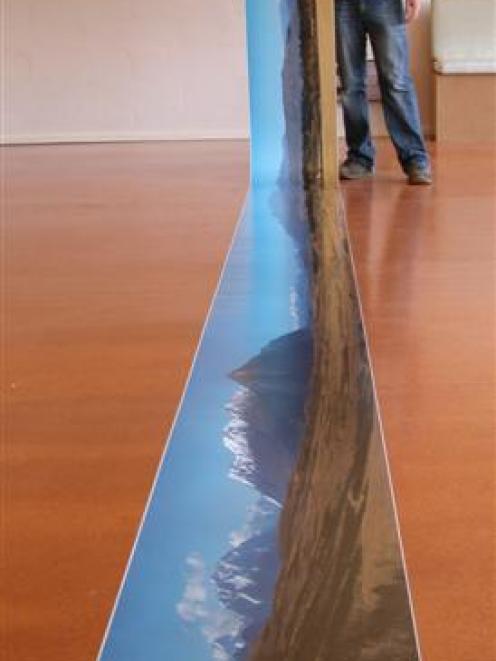 Weston photographer Derek Golding with an 8m photograph, believed to be New Zealand's widest. The...